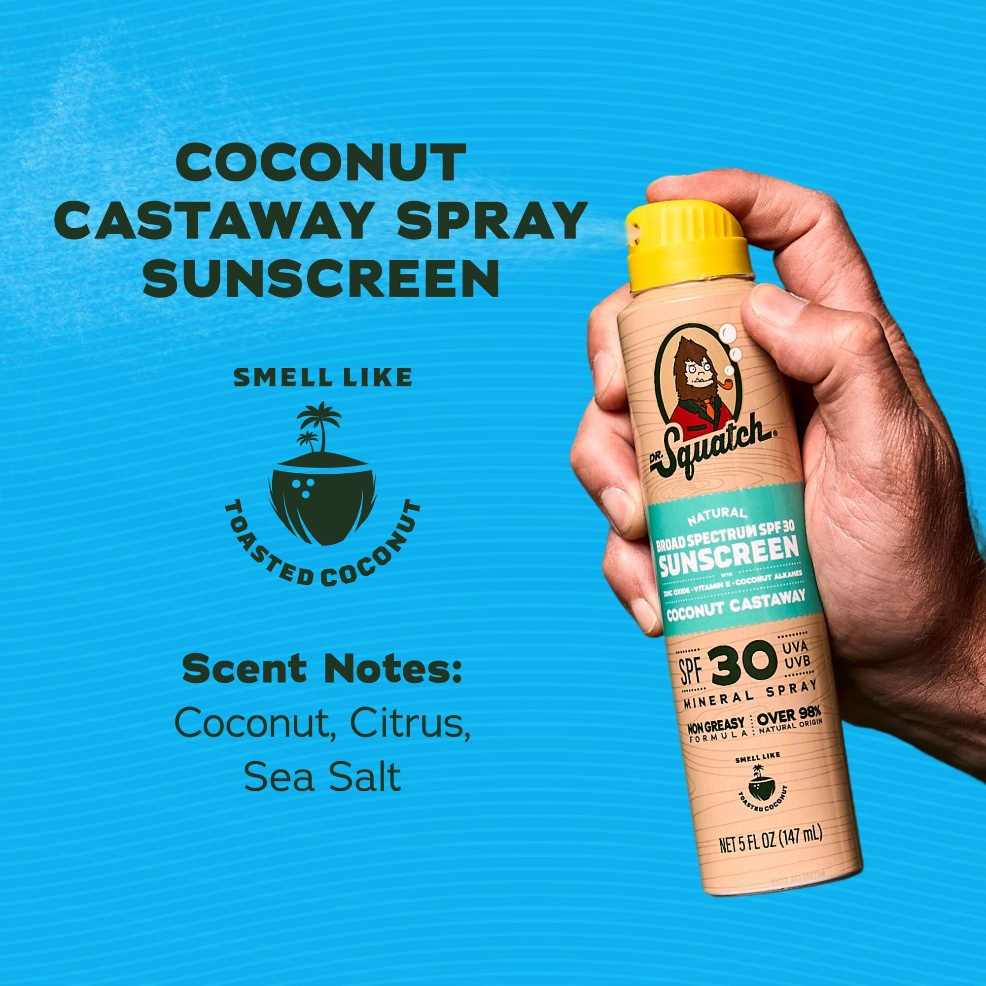 Hand holding and spraying a Dr. Squatch Coconut Castaway SPF 30 Spray Sunscreen against a blue background.